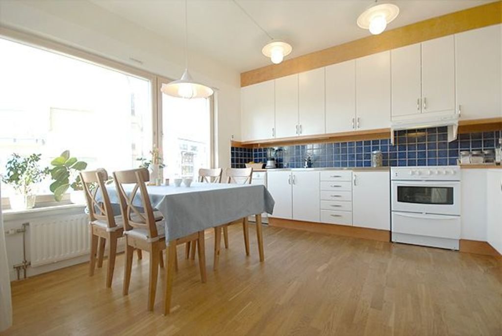 Open kitchen and dining room with natural light and timber floors